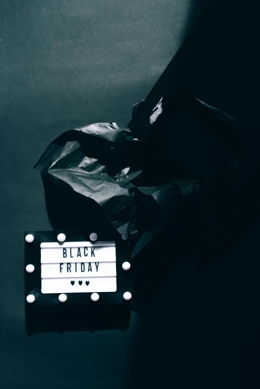 a black and white photo of a black friday sign, by Julia Pishtar, pexels contest winner, dark vador, wrapped in black, holiday, blackout