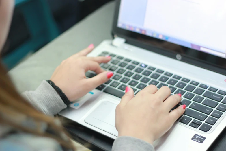 a close up of a person typing on a laptop, school curriculum expert, multiple stories, round-cropped, high quality image