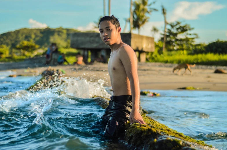 a young man riding a wave on top of a surfboard, by Andrée Ruellan, pexels contest winner, happening, philippines, avatar image, childish look, actor