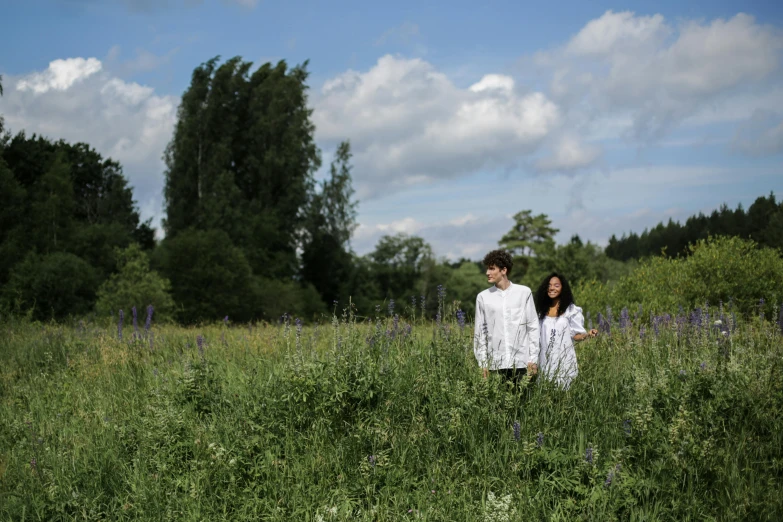 a couple standing in a field of tall grass, by Anato Finnstark, unsplash, botanic garden, dezeen, charli bowater and artgeem, forest picnic