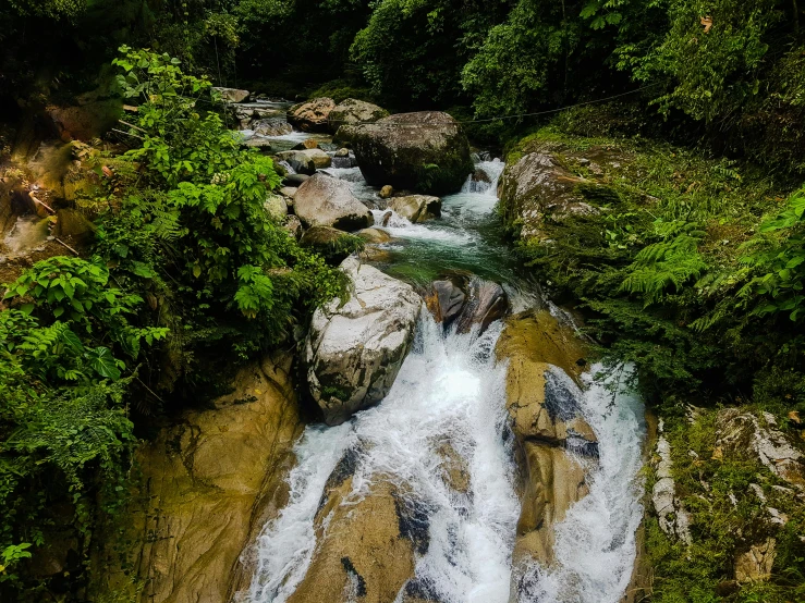 a river running through a lush green forest, an album cover, by Peter Churcher, pexels contest winner, sumatraism, white water, kuala lumpur, thumbnail, streams and rocks