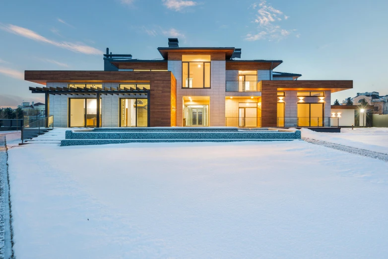 a large house sitting on top of a snow covered field, by Andrew Stevovich, pexels contest winner, bauhaus, outdoor lighting, bright modern style, profile pic, thumbnail