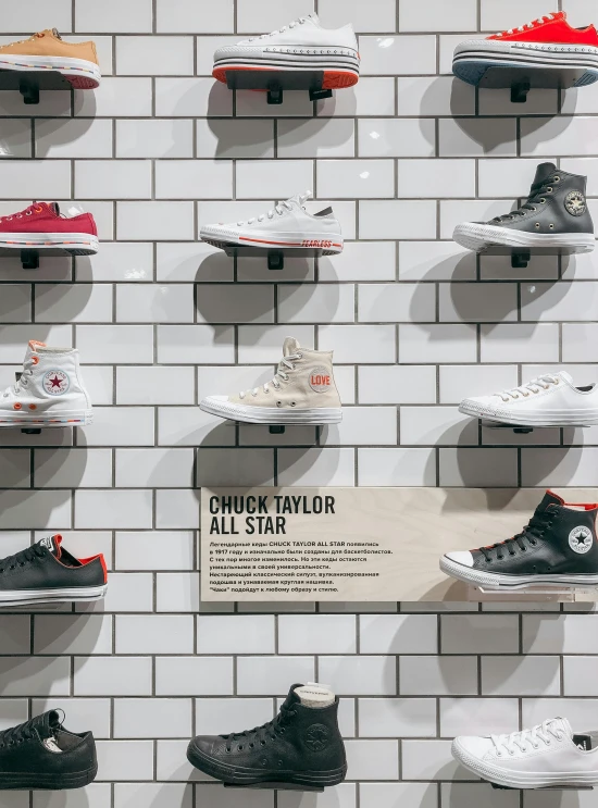 a wall filled with lots of different types of shoes, by Carey Morris, trending on unsplash, inside a frame on a tiled wall, award winning shopfront design, converse, on white