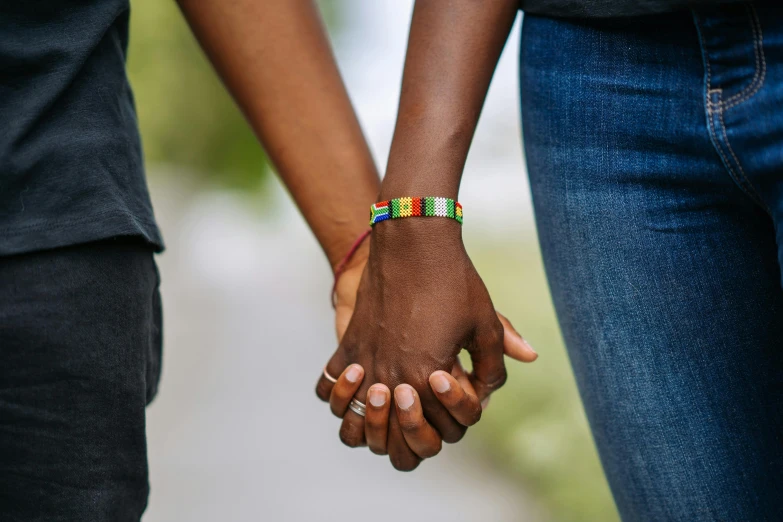 a close up of two people holding hands, by Arabella Rankin, trending on pexels, jamaican colors, pride month, profile image, thumbnail