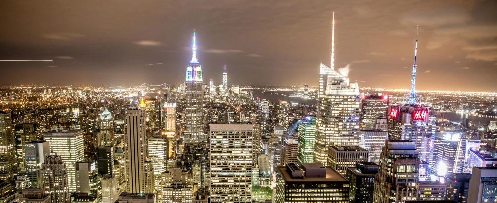 a view of a city at night from the top of a building, new york buildings, light show, instagram post, slide show