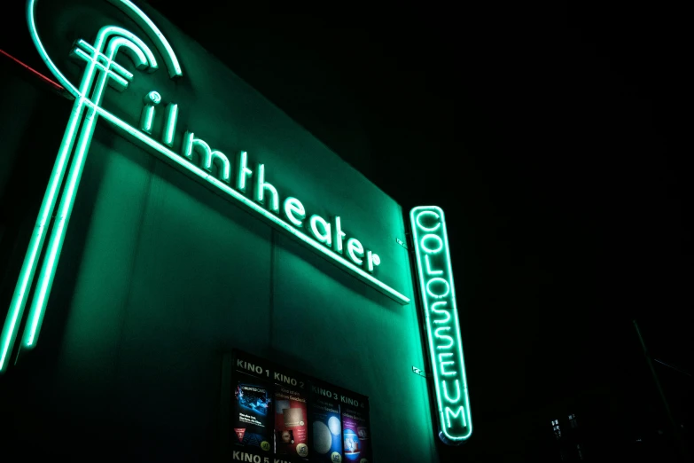 a green neon sign on the side of a building, a hologram, unsplash contest winner, photorealism, coliseum, blockbuster movie, kinemacolor, ( ( theatrical ) )