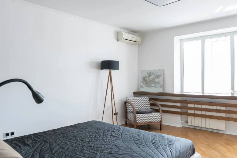 a bed sitting in a bedroom next to a window, by Adam Marczyński, light and space, air conditioner, flat grey, flat, sangsoo jeong