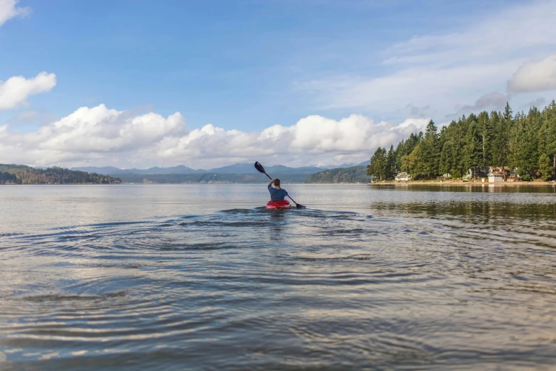 a person in a kayak paddling on a lake, cascadia, fan favorite, exterior shot, mechabot