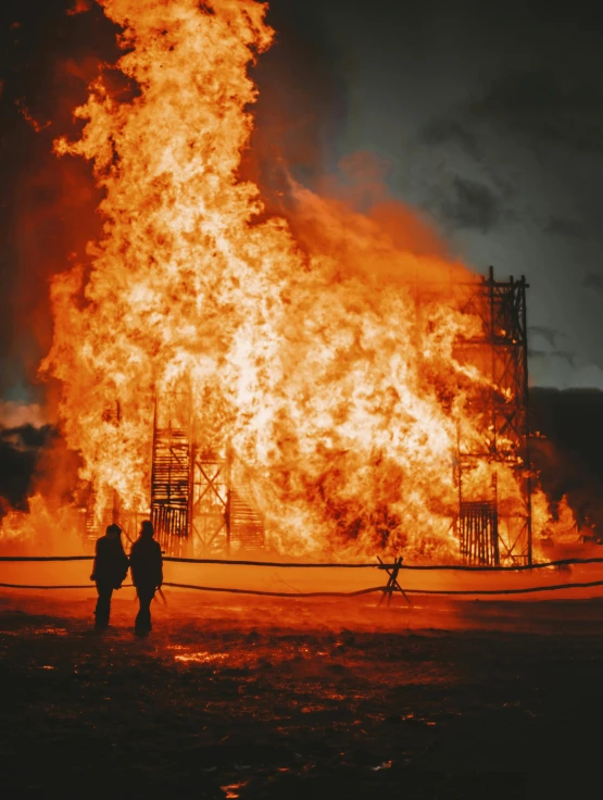 two people standing in front of a large fire, an album cover, pexels contest winner, demolition, profile image, firefighting gear, olafur eliasson