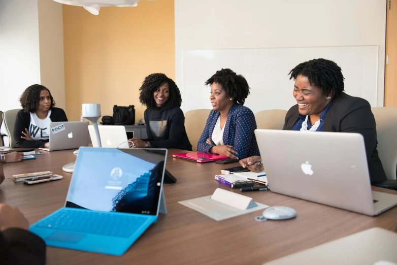 a group of people sitting around a table with laptops, afro tech, profile image, thumbnail, high-resolution