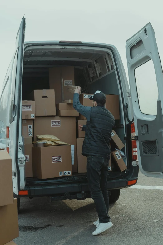 a man loading boxes into the back of a van, pexels contest winner, renaissance, curated collections, video footage, post+processing, ignant