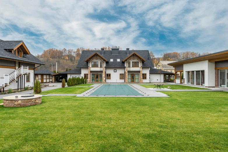 a large house with a pool in the yard, by Franz Hegi, pexels contest winner, slovakia, modern rustic, panorama view, lawn