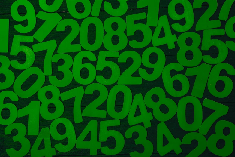 a pile of green numbers sitting on top of a table, green background, thumbnail, digital image