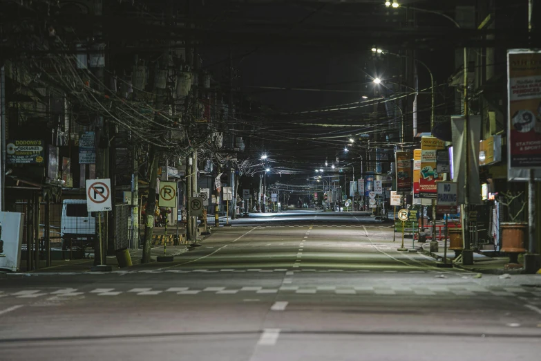 an empty street in a city at night, a portrait, unsplash contest winner, shin hanga, manila, japanese rural town, wires everywhere, headlights turned on