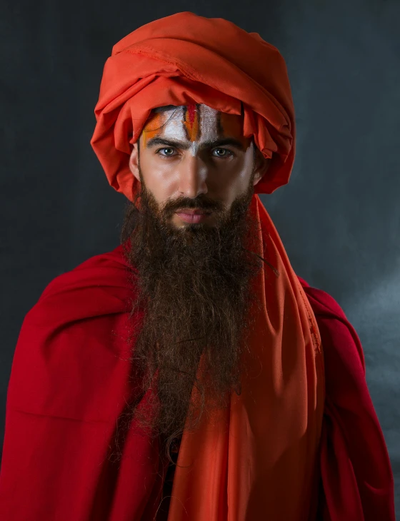 a man with a long beard wearing an orange turban, a character portrait, pexels contest winner, mannerism, non binary model, hinduism, a red cape, mid-shot of a hunky
