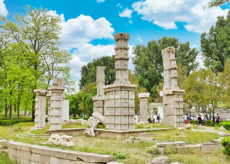 a group of stone pillars sitting on top of a lush green field, a marble sculpture, inspired by Li Di, pexels contest winner, baotou china, demolition, celestial gardens, beijing