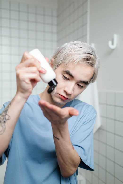 a man brushing his teeth in a bathroom, by Jang Seung-eop, reddit, pale hair, flawless epidermis, sprays, with blue hair