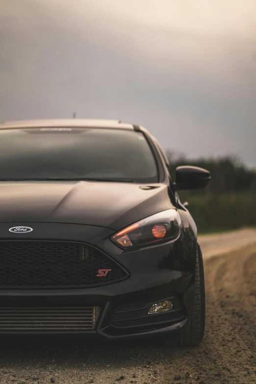 a black car parked on the side of a road, by Adam Marczyński, pexels contest winner, ford, square, front face, sport