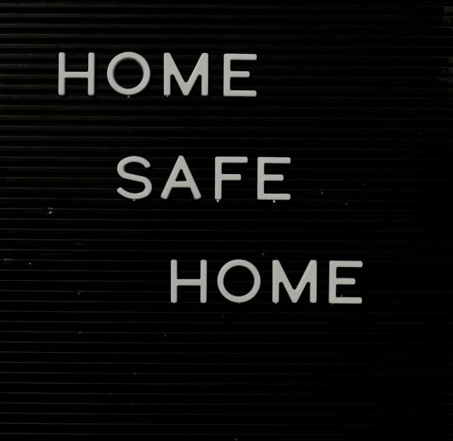 a black and white photo of a sign that says home safe home, a poster, by Ian Hamilton Finlay, pixabay, worksafe. 2000s, apartment with black walls, 256x256, crimes