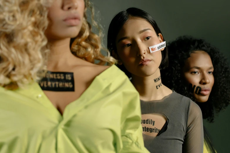 a group of women standing next to each other, inspired by Vanessa Beecroft, trending on pexels, stickers, wearing collar, placards, transparent