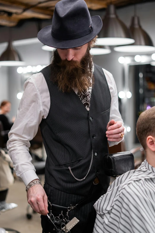 a man getting his hair cut at a barber shop, wearing a waistcoat, epic beard, wearing a chain, style of marcin blaszczak