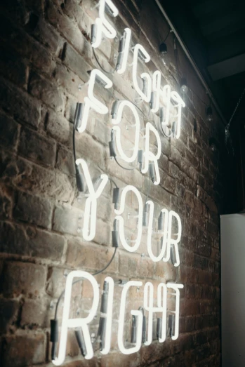 a brick wall with a neon sign that says fight for your right, trending on pexels, light and space, light bulb, instagram story, rococo cyber neon lighting, delightful surroundings