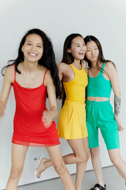 a group of young women standing next to each other, inspired by helen huang, happening, wearing a camisole and shorts, juicy color, product shot, center of image