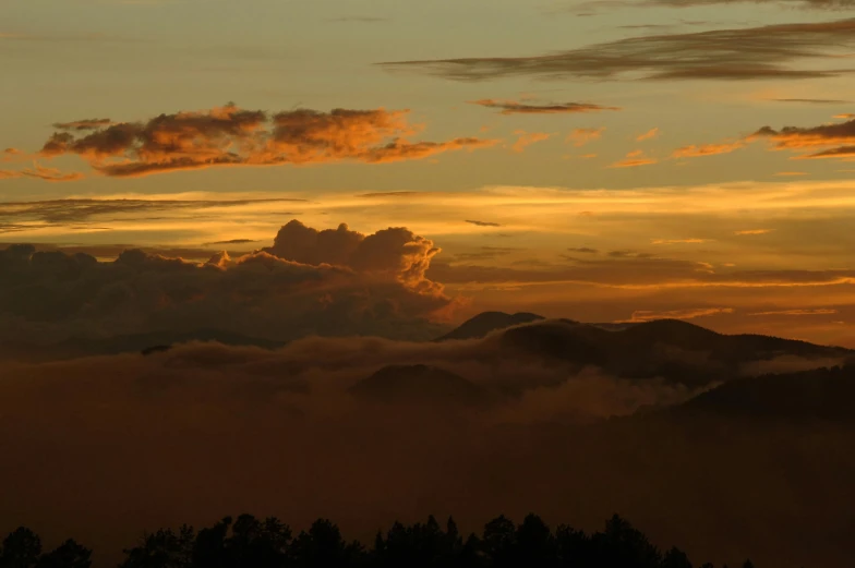 there is a plane that is flying in the sky, by Jessie Algie, pexels contest winner, romanticism, mountain sunrise, layered stratocumulus clouds, light orange mist, today\'s featured photograph 4k