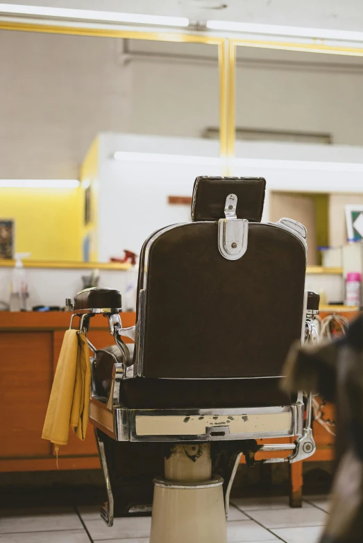 a dog sitting in front of a barber chair, by Matt Cavotta, trending on unsplash, altermodern, yellow, from back, thumbnail, 1 9 4 0 s haircut