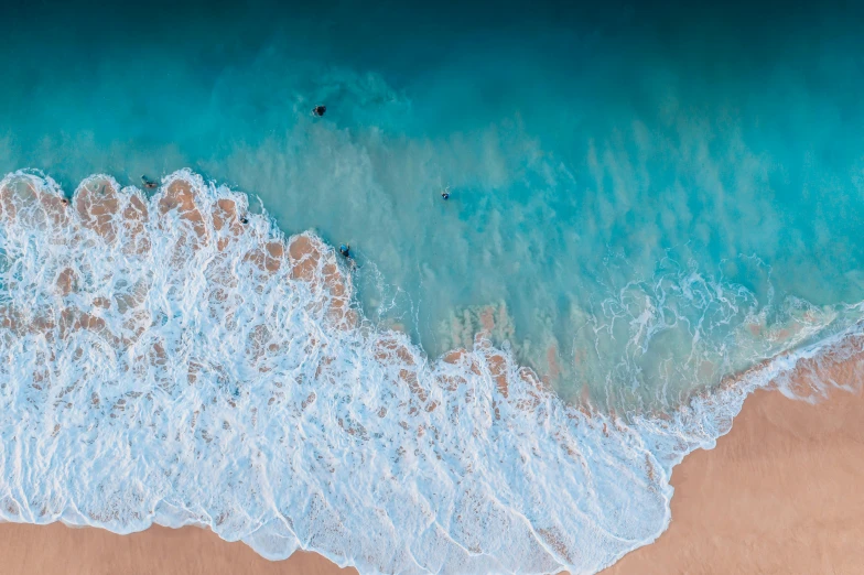 a large body of water next to a sandy beach, by Robbie Trevino, pexels contest winner, ocean pattern, aquamarine, manly, flight