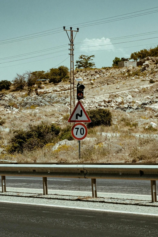 a speed limit sign on the side of a road, by Nathalie Rattner, unsplash, les nabis, jerusalem, downhill landscape, instagram story, construction