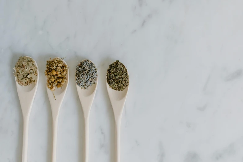 four spoons filled with different types of herbs, by Emma Andijewska, trending on unsplash, renaissance, all marble, healthcare, ignant, 3 - piece