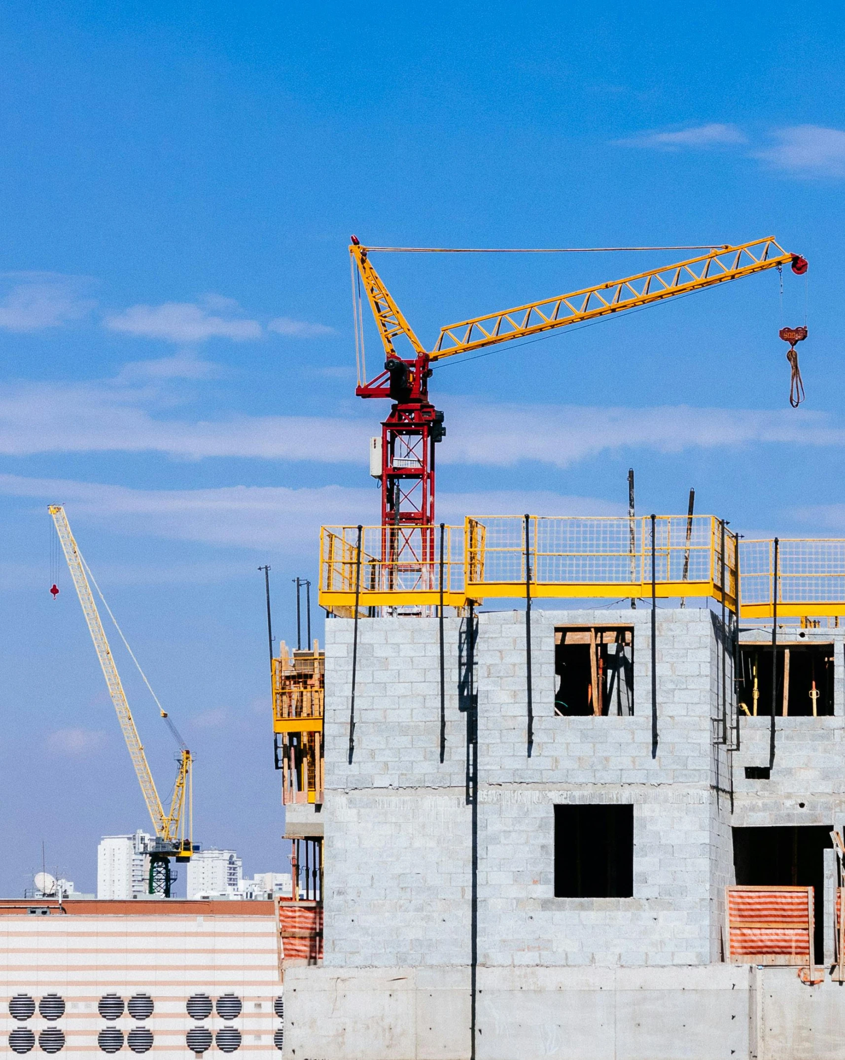 a crane standing on top of a building under construction, by Carey Morris, pexels contest winner, commercial banner, lgbtq, thumbnail, multiple stories