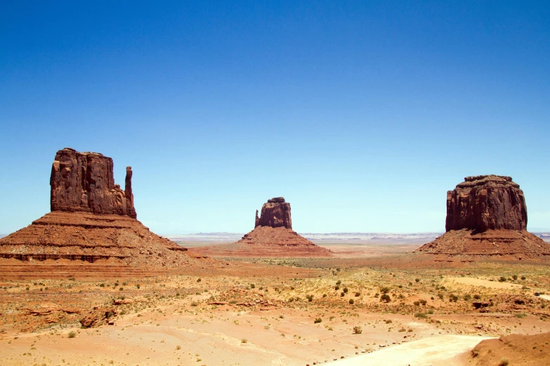 two large rock formations in the middle of a desert, by Pamela Ascherson, pexels contest winner, three towers, 2000s photo, fan favorite, sweeping vista