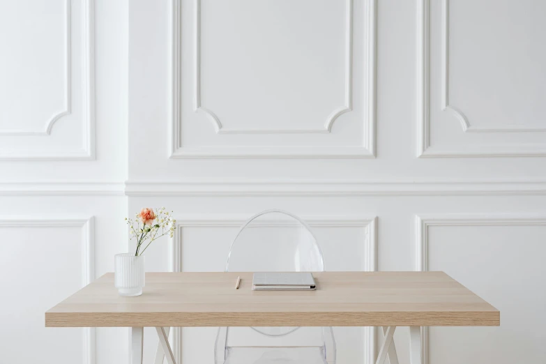 a white chair sitting next to a wooden table, inspired by Wilhelm Hammershøi, trending on pexels, white backdrop, ornate designs on desk, transparent backround, smooth panelling