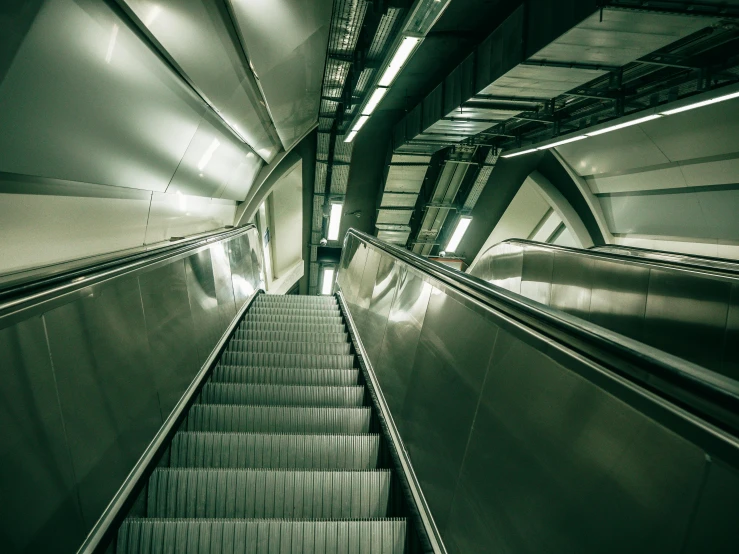 an empty escalator in a subway station, inspired by Zaha Hadid, unsplash contest winner, down in the sewers of london, elevator, hyperrealistic ”, instagram post