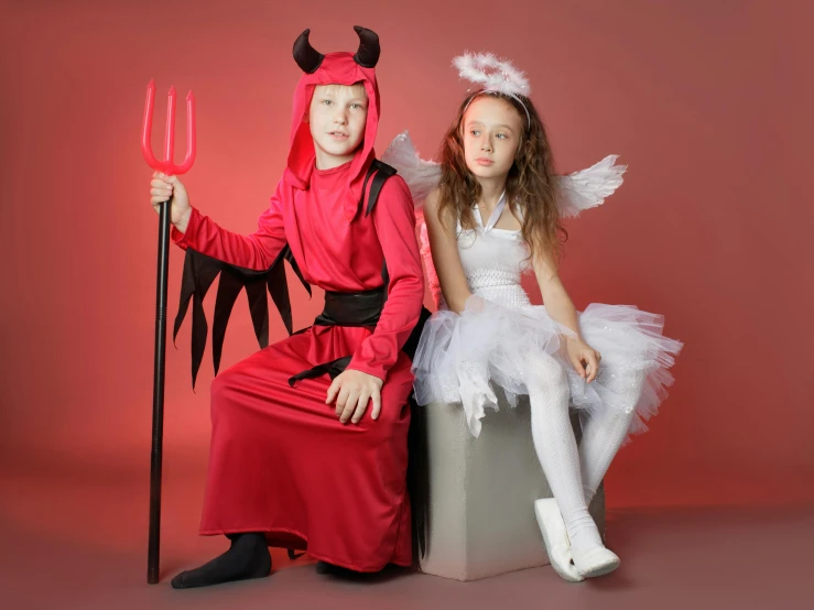 a little girl dressed as a devil and a little girl dressed as a devil, an album cover, pexels, lycra costume, angel, best on adobe stock, boys