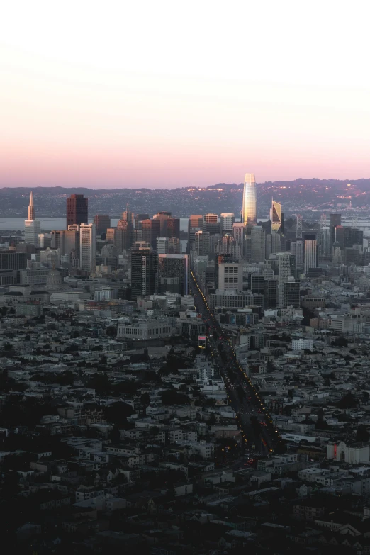 a view of a city from the top of a hill, by Dan Scott, unsplash contest winner, happening, sf, dusk light, view from helicopter, ignant