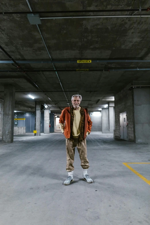 a man standing in an empty parking garage, a silver haired mad, wearing cargo pants, tjalf sparnaay, cardboard