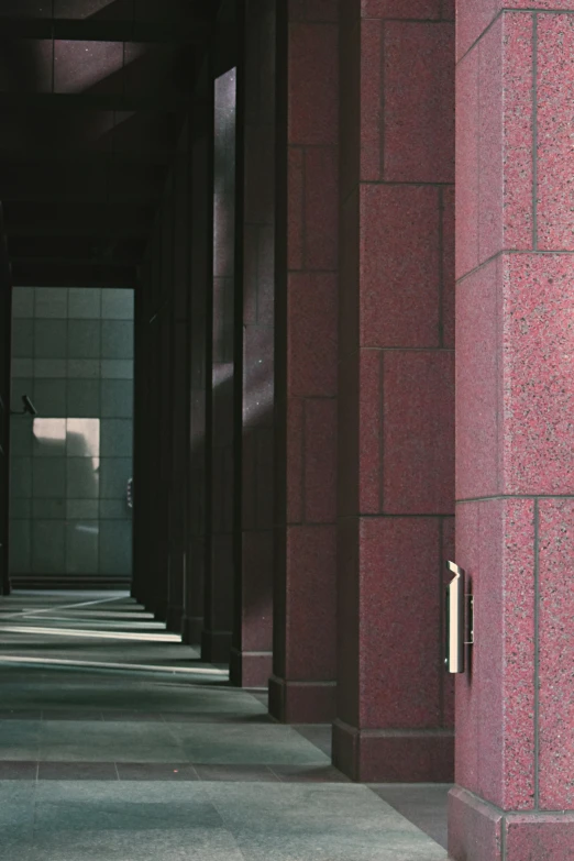 a man riding a skateboard down a sidewalk next to a building, inspired by Ricardo Bofill, unsplash, brutalism, maroon metallic accents, stone tile hallway, 4k detail, color ektachrome photograph