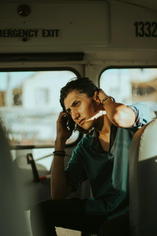 a woman sitting on a bus talking on a cell phone, trending on pexels, happening, portrait of a rugged young man, amr elshamy, with his hands in his hair, serious