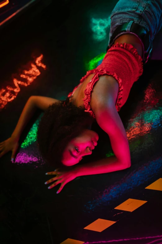 a woman laying on the floor in a neon room, inspired by David LaChapelle, pexels contest winner, funk art, glowing street signs, sza, medium closeup, dancefloor kismet