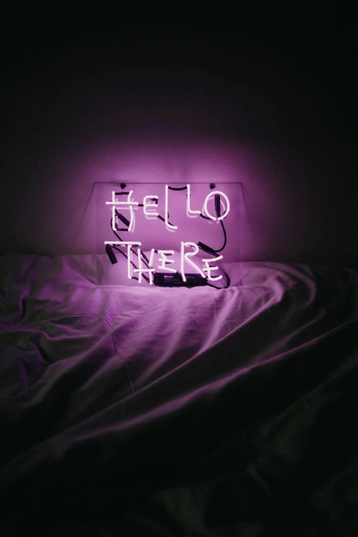 a purple neon sign sitting on top of a bed, an album cover, unsplash contest winner, hello, i'm here, ello, let there be light