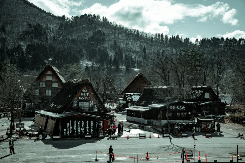 a group of people riding skis down a snow covered slope, a tilt shift photo, pexels contest winner, ukiyo-e, cottage town, black forest, dark gloomy, a wooden