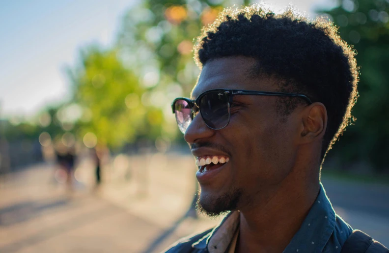 a close up of a person wearing sunglasses, by Washington Allston, smiling male, dark skinned, cinematic shot ar 9:16 -n 6 -g, nice weather