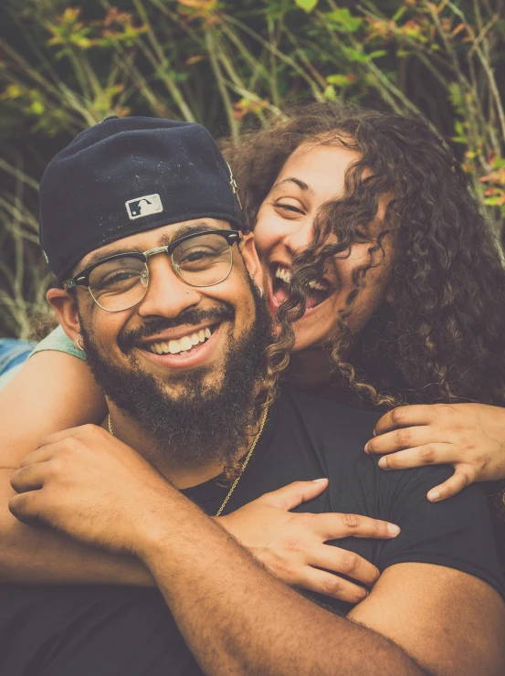 a man and a woman posing for a picture, pexels contest winner, curly black beard, hugging each other, ariel perez, immature