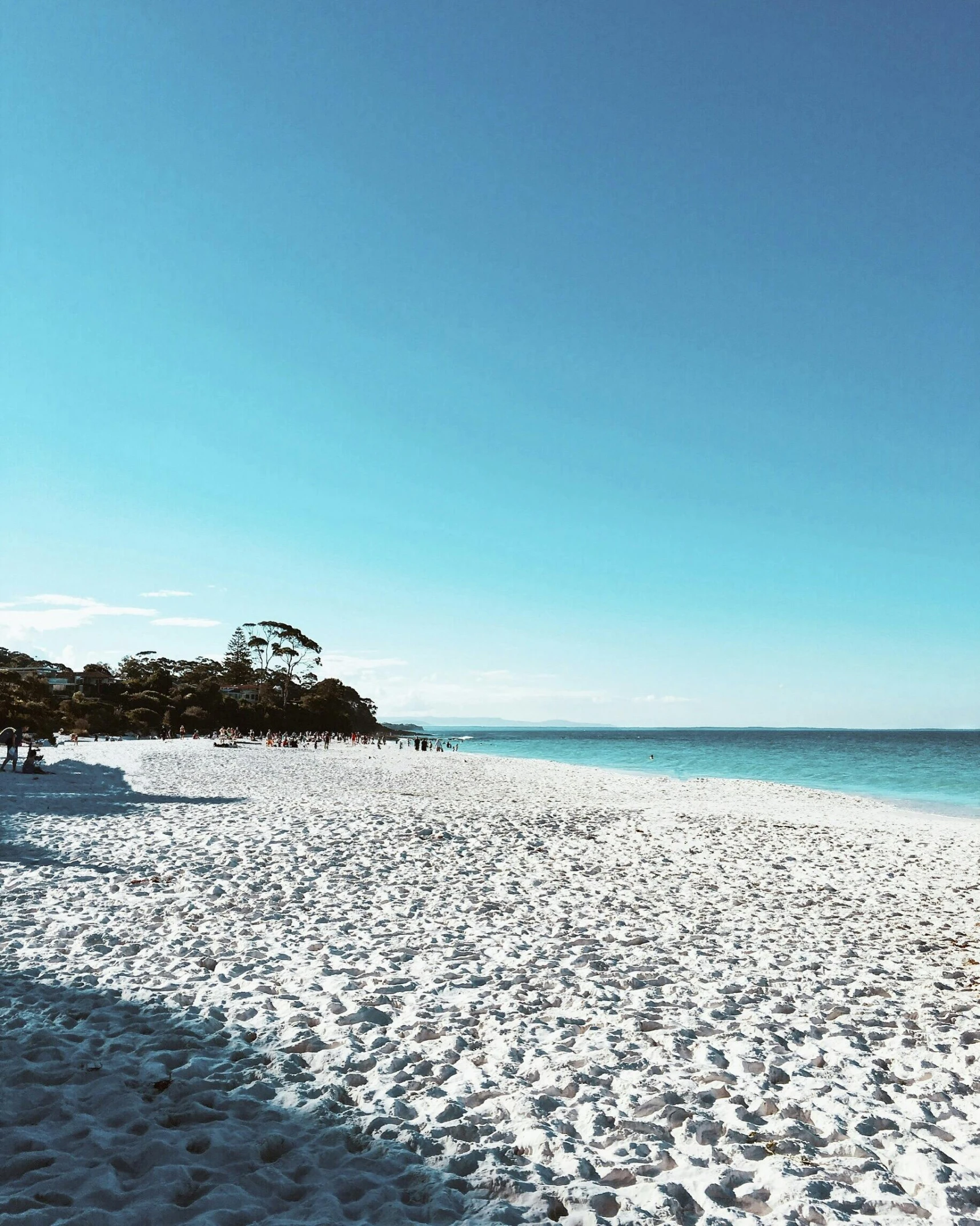 a group of people standing on top of a sandy beach, white sand, crisp and clear, instagram post, manly