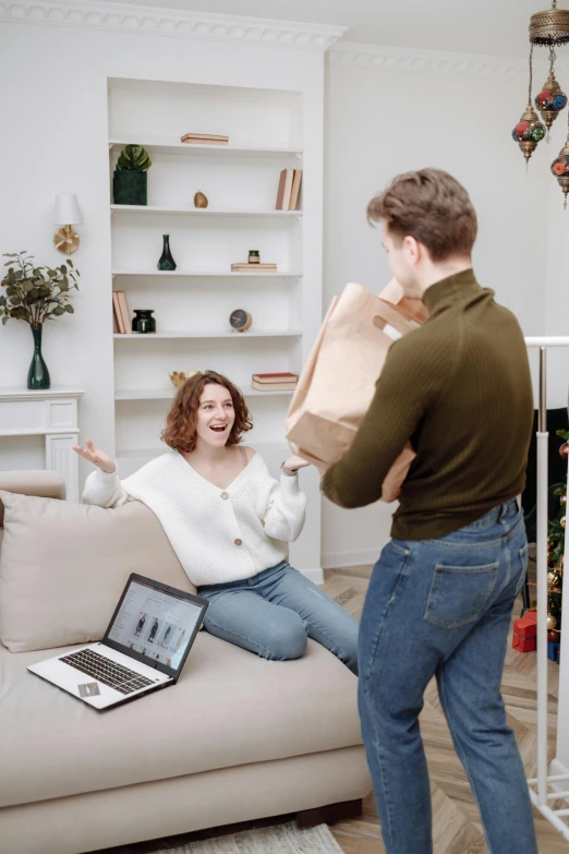 a man and woman sitting on a couch in a living room, pexels contest winner, happening, exiting store, excited russians, gif, holding a gold bag