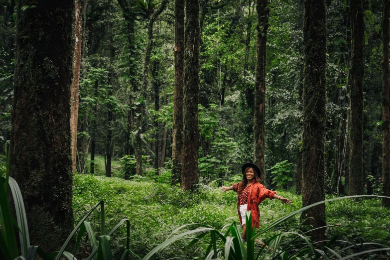 a woman standing in the middle of a forest, sumatraism, avatar image