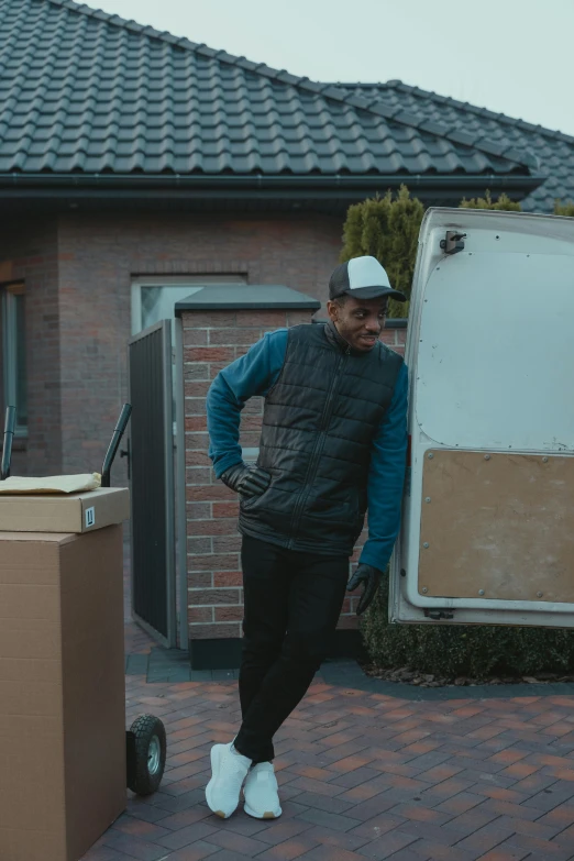a man standing in front of a moving truck, pexels contest winner, realism, home video footage, black man, about to enter doorframe, loish van baarle